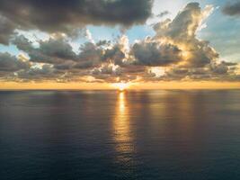 Drone shot of a cloudy sunset over the sea photo