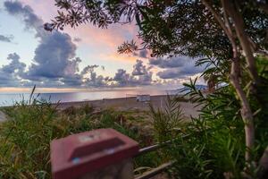 Majestic beach during sunset golden hour and cloudy sky photo