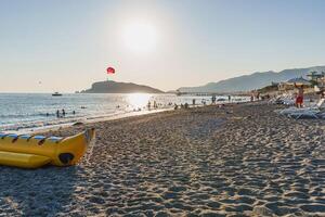 Watersports and paragliding on the beach in summer photo