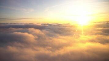 Amazing view from plane on the sky, sunrise, and clouds. Footage. Haven lit by golden sun and soft white clouds on blue sky background. video