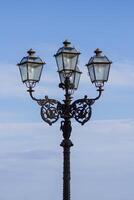 Street chandelier under blue sky photo