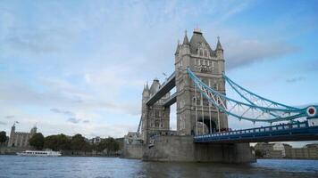 Canal in city on background of large bridge with towers. Action. Beautiful port channel is located in big city with beautiful bridge. Beautiful old architectural bridge with towers video