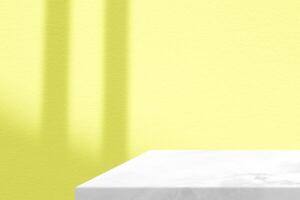 White Marble Table Corner with Light Beam, Shadow, and Spotlight on the Yellow Concrete Wall Background, Suitable for Product Presentation Backdrop, Display, and Mock up. photo