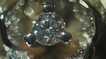 Diamond solitaire ring closeup in dark environment. Big blue diamond, closeup view. layered triangular macro diamond shapes with a small diamond over them. Round gemstone on Black Background with video