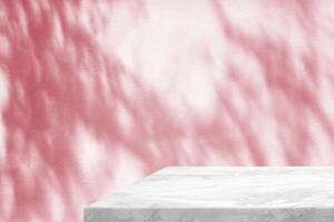 Minimal White Marble Table Corner with Shadow and Pink Light Beam on Concrete Wall Background, Suitable for Product Presentation Backdrop, Display, and Mock up. photo