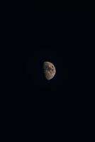 Moon in its full glory in a dark sky. Holes and depressions on an orbiting body in outer space. The white-grey moon photo