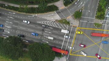 Top view of a city intersection with a bus, cars and people crossing the street. Shot. Traffic at daytime, rossroad in the center of big city, aerial top view. video