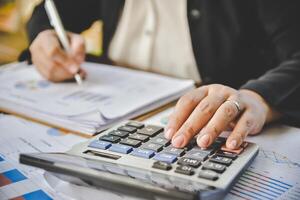 Businessman are working with a calculator and document. Meeting report in progress. in office business concept photo