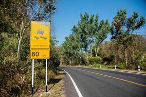 Signs on the way in the yellow, beware of rain photo