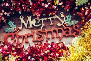 Christmas decorations and Merry christmas greetings on a wood background. photo