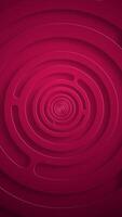 Vertical video - stylish red abstract background with gently rotating concentric circles. This simple geometric technology background animation is full HD and a seamless loop.