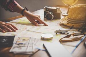 Travelers are planning a trip by searching the route on the map and searching for information on the internet. photo