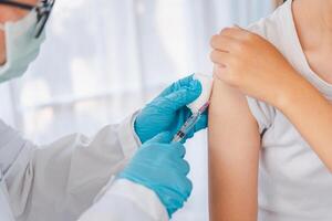 The doctor is currently treating patients by injecting arms. Vaccination or medication to prevent and treat viruses. photo