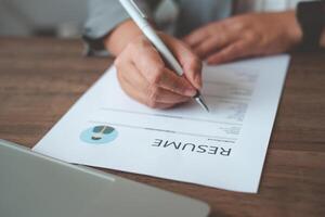 People are filling out their resume on the job application form to apply for a job at a company. photo