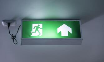 The emergency exit sign shows the way out. photo