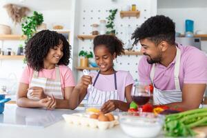 Family In Kitchen Making Morning Breakfast Together. Happy family in the kitchen having fun and cooking together. Healthy food at home. photo