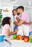 Family In Kitchen Making Morning Breakfast Together. Happy family in the kitchen having fun and cooking together. Healthy food at home. photo