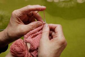 hands of senior woman knitting photo