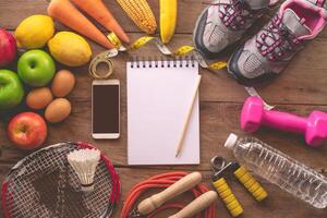 fitness concept with Exercise Equipment on wooden background. photo