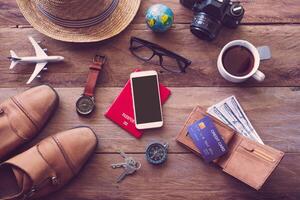 Travel accessories on wooden floor ready for travel photo