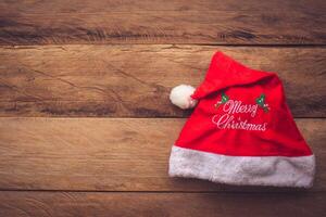 Christmas hat placed on wooden floor. photo