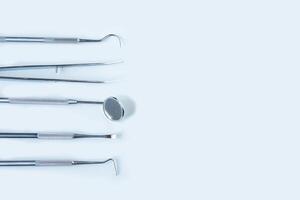 close up dentist  tools for teeth care at white background top view photo