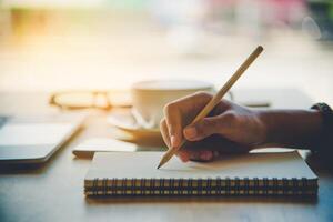 Closeup of woman's hand writing on paper photo