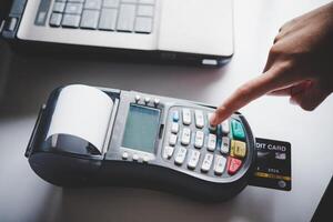 Paying by credit card , buying and selling products using a credit card swipe machine photo