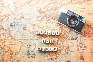 keywords TRAVEL THE WORLD are on the world map. Tourism concept photo