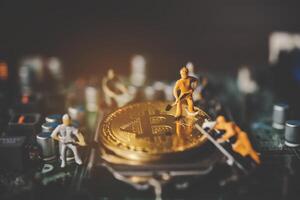 miniatura personas o pequeño figura trabajador en oro bitcoin poco moneda criptomoneda bancario dinero digital poco moneda btc moneda tecnología negocio Internet concepto. foto