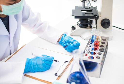 The scientist is recording the scientific value on a note. In an experiment in the LAP room photo