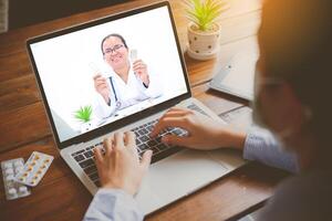 The patient's viewpoint consult with the doctor via social media such as laptop, smartphone, almost. The work for home concept of doctors and patients. photo