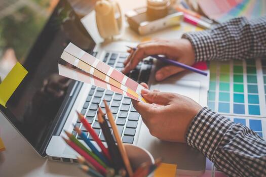 The graphic designer creative team is currently working on the design and color selection on the guide color for advertising design. photo