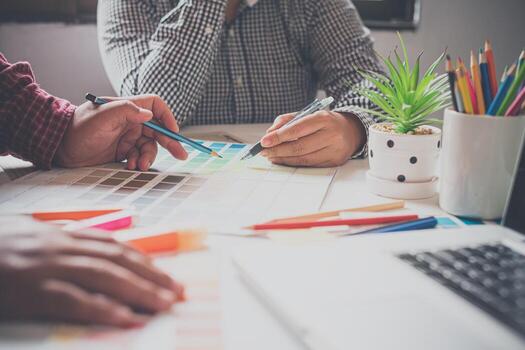 The graphic designer creative team is currently working on the design and color selection on the guide color for advertising design. photo