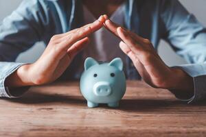 hand holding piggy bank, saving money and finance accounting concepts photo