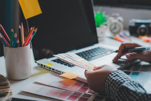 The graphic designer creative team is currently working on the design and color selection on the guide color for advertising design. photo
