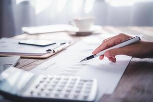 businessman pointing with pen on business report chart are working on accounts in business analysis with graphs and documentation. photo