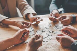 Business team handle a piece of white puzzles that are about to drop to get a complete worksheet - An attempt to succeed. photo