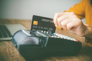 Paying by credit card , buying and selling products using a credit card swipe machine photo