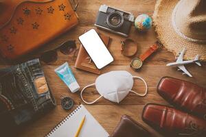 Protecting COVID-19 while Traveling. Travel accessories costumes. Passports, luggage, The cost of travel maps prepared for the trip .concept new normal lifestyle photo