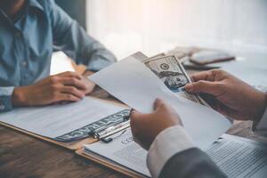 businessman was negotiating an agreement in which the dollar was accepted as a bribe in corruption. anti bribery and corruption concepts photo