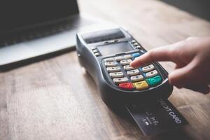 Paying by credit card , buying and selling products using a credit card swipe machine photo