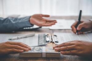 businessman was negotiating an agreement in which the dollar was accepted as a bribe in corruption. anti bribery and corruption concepts photo