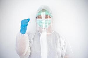 doctor in a PPE uniform that prevents the COVID-19 situation and raises his fist. photo