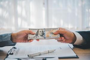 businessman was negotiating a bribery arrangement in which the dollar would be accepted as a bribe. Concepts of anti-bribery and anti-corruption photo