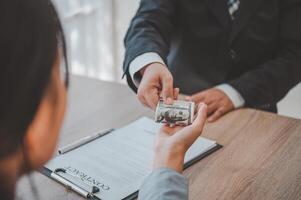 businessman was negotiating a bribery arrangement in which the dollar would be accepted as a bribe. Concepts of anti-bribery and anti-corruption photo