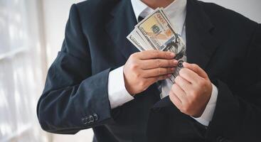 businessman was negotiating a bribery arrangement in which the dollar would be accepted as a bribe. Concepts of anti-bribery and anti-corruption photo