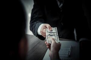 businessman was negotiating a bribery arrangement in which the dollar would be accepted as a bribe. Concepts of anti-bribery and anti-corruption photo