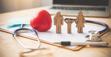 Medical Insurance Concept With Family And Stethoscope On Wooden Desk photo