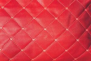 close-up red leather sofa backrest background photo